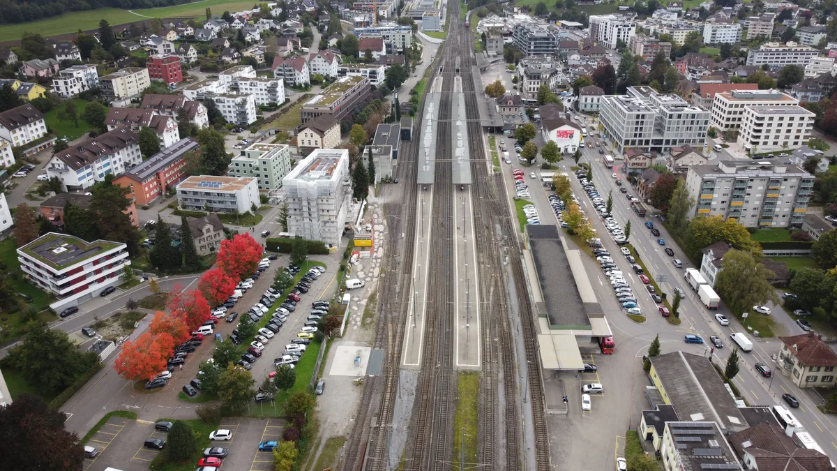 Auf dieser Aufnahme ist gut zu sehen, wie viel kürzer das Perron am Gleis 1 (hier rechts im Bild) im Bahnhof Wetzikon ist. Auf diesem Gleis verkehrt die S3 nach Effretikon. Blick aus der Luft auf den Bahnhof Wetzikon.